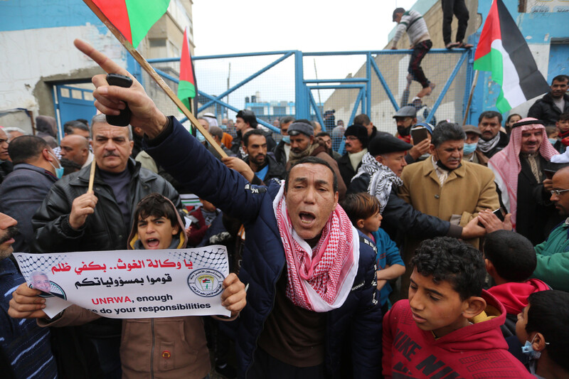 People carry flags and banners during a protest