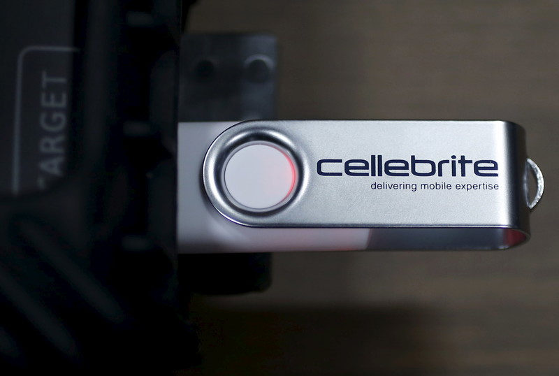 A USB with "Cellebrite" written on it is plugged into a device