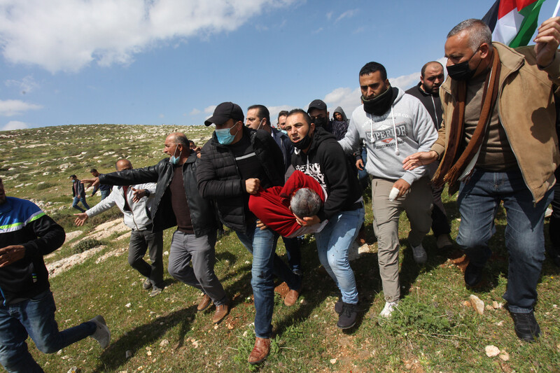 Men carry the body of an injured protestor 