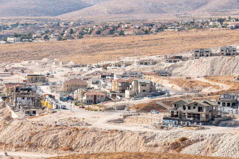 Broad view of unfinished buildings against arid landscape