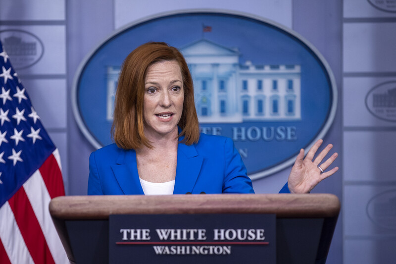 Woman at podium gesticulates