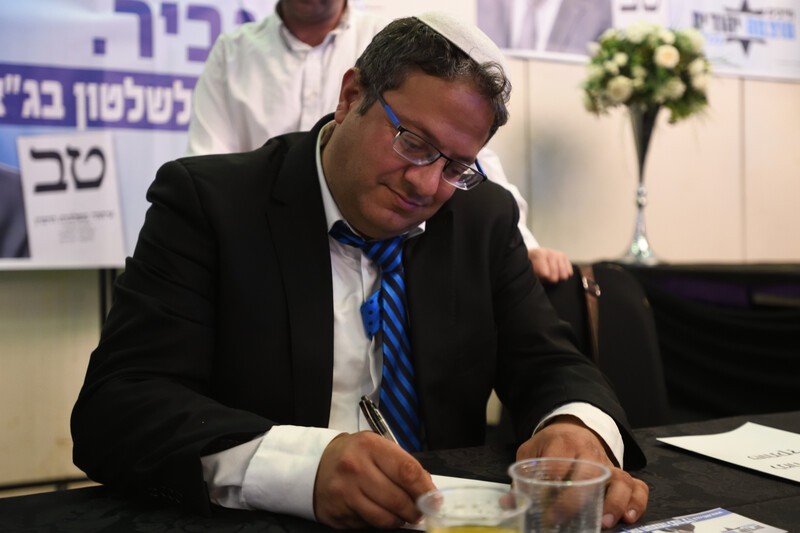 A man writes notes at a desk 