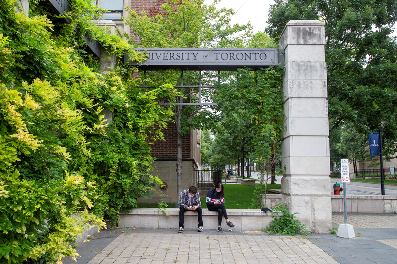 Two people sit on a bench