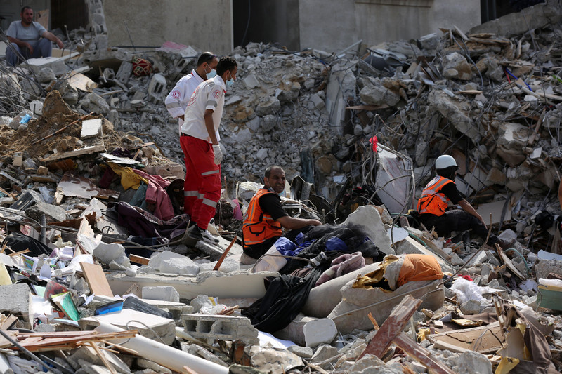 Rescue workers search in rubble from destroyed building 