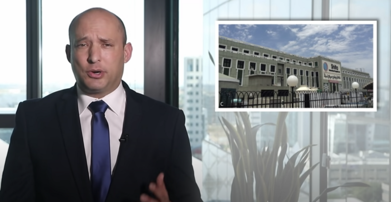 Man speaks on screen with photo of building inset