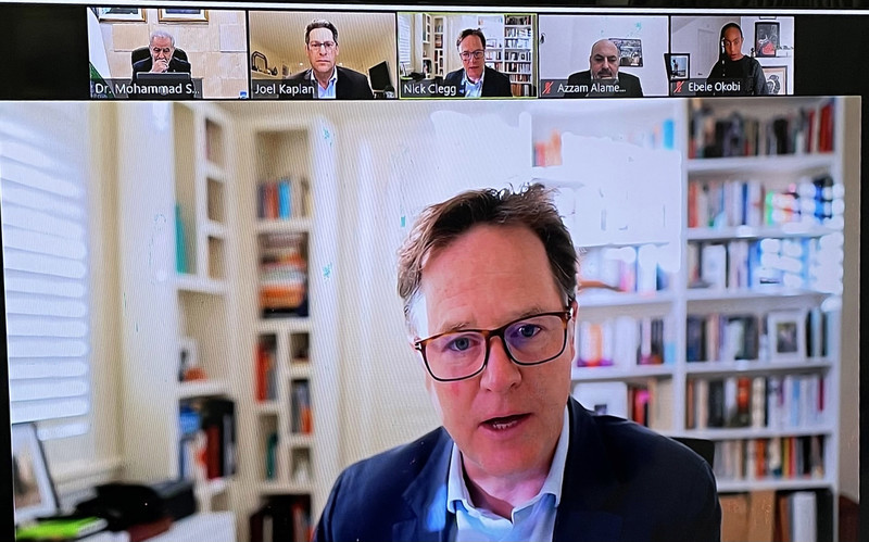 Four men shown on screen in a virtual meeting