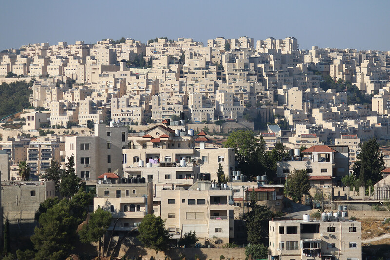 Densely-packed apartment buildings fill a landscape