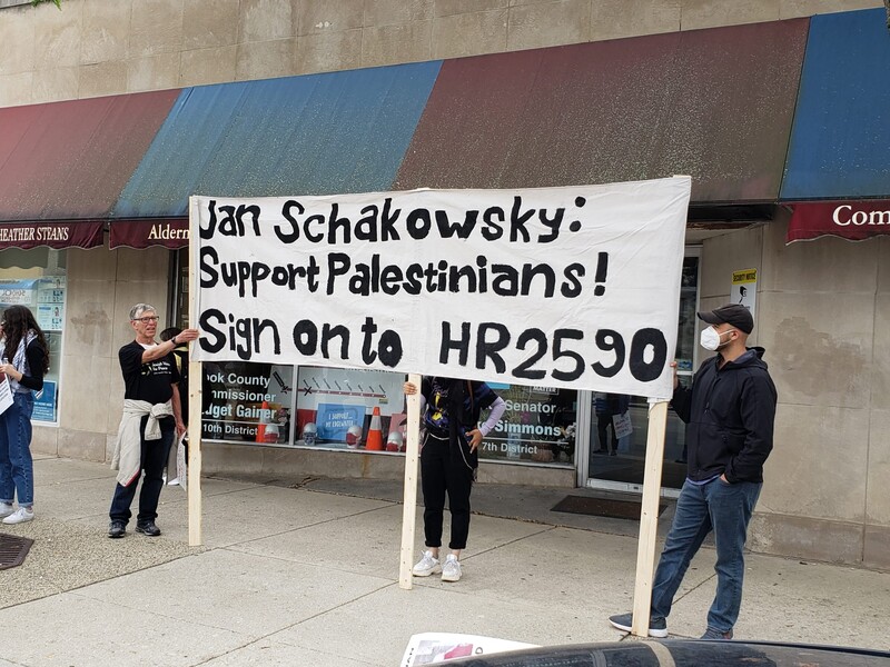 Protesters hold a sign. 