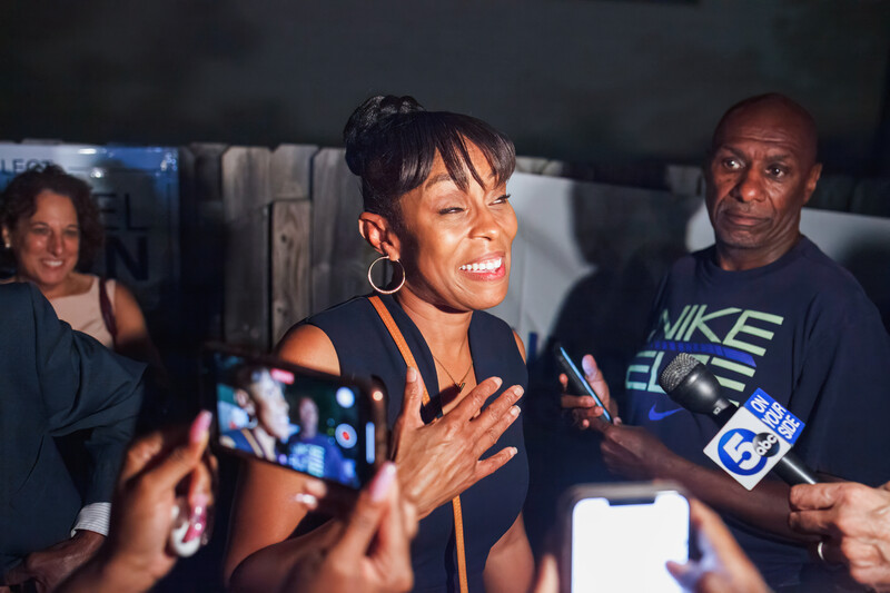 Woman expresses joy before two onlookers