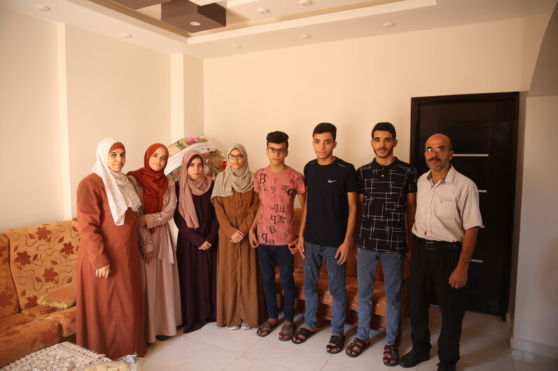 Four men and four women of one family pose for the camera