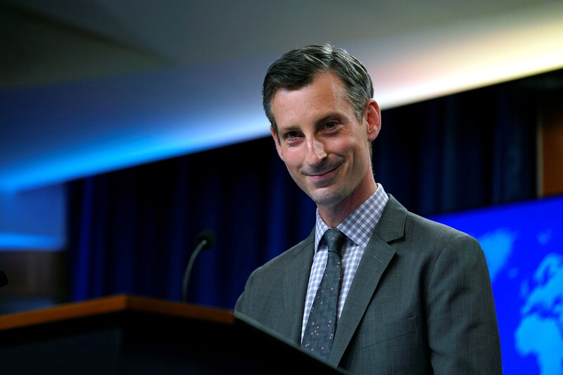 Man at podium smiles