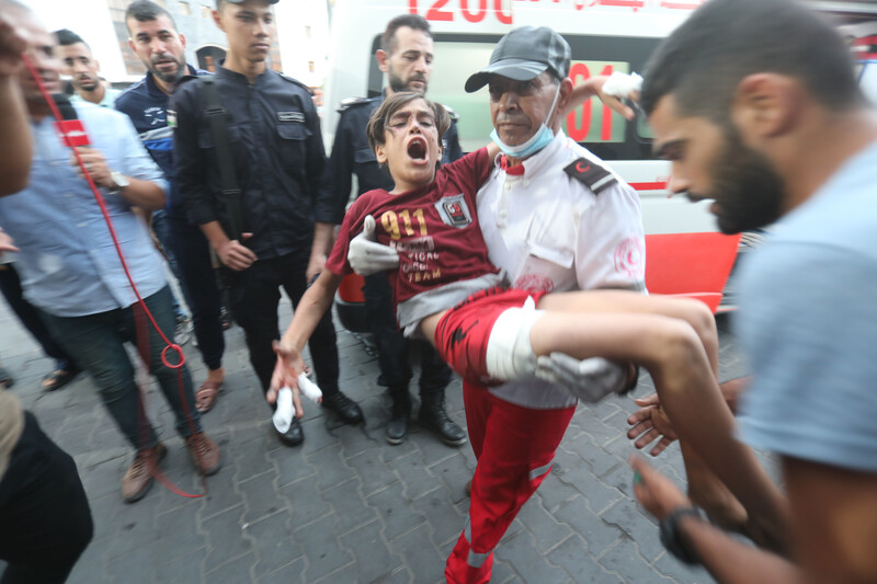 Paramedic carries wounded boy