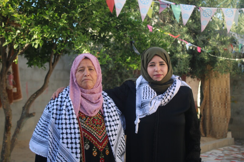 Two women pose for the camera