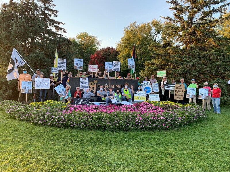 Protesters with signs pose for group photo