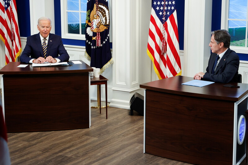 Two men seated at tables