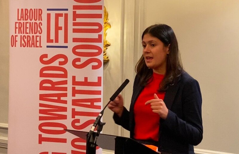 A woman speaks from a lectern