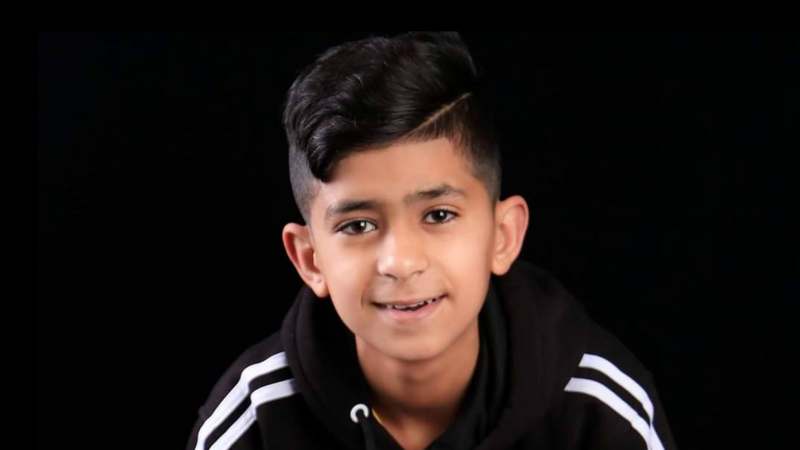 A portrait of a young boy smiling at the camera