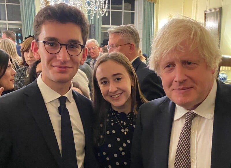 Three people posing at a reception