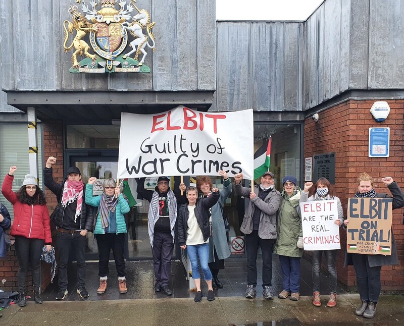 Protesters with signs outside a court