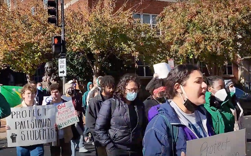 Students hold signs during a protest