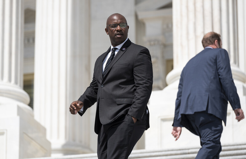 Two men in suits with their backs towards one another