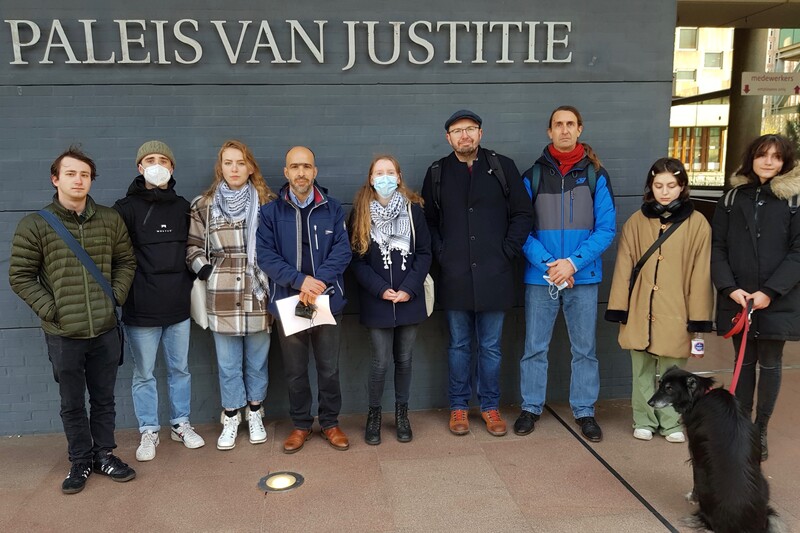 People stand together in front of modern building