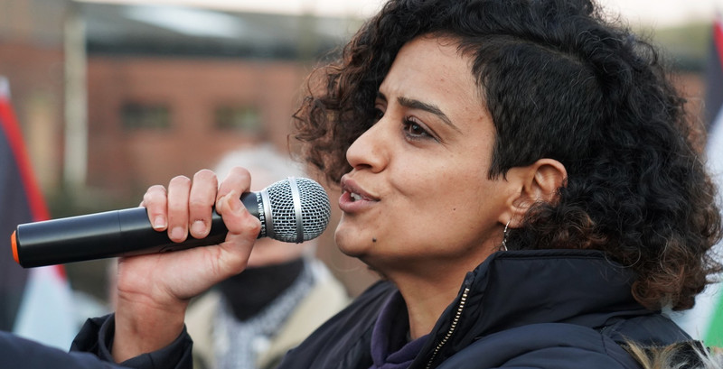 A woman speaks into a microphone