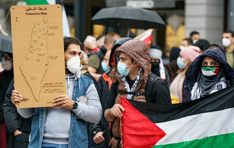 Protesters hold a map of Palestine