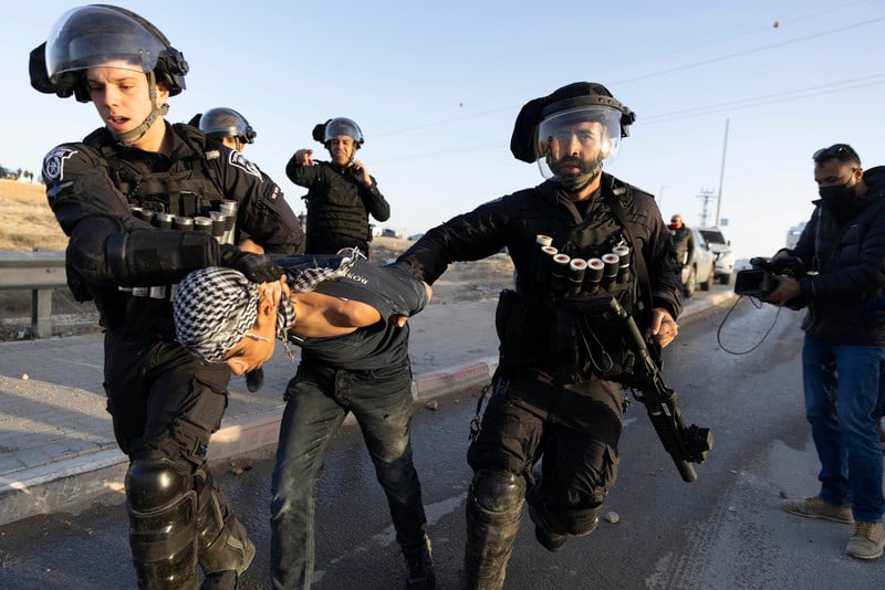 Two heavily armed Israeli police arrest a young boy 