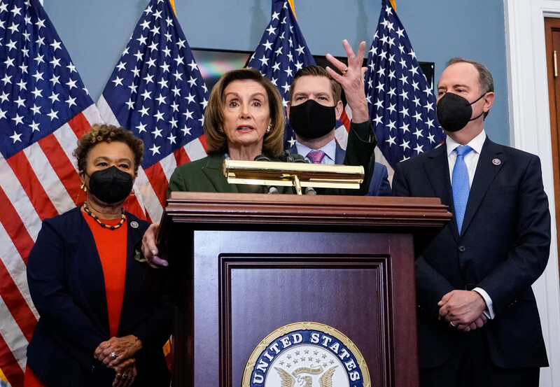 Members of Congress stand at podium