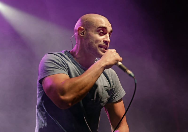 A man on stage holding a microphone