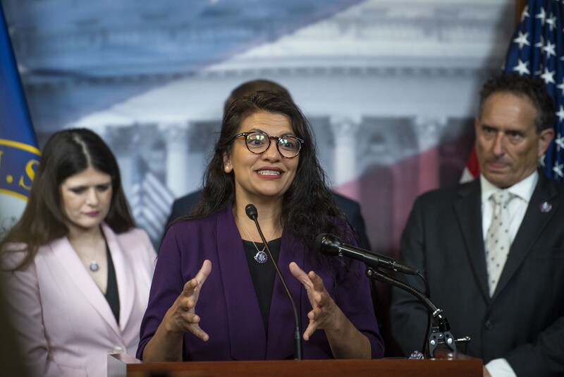 Three people at podium