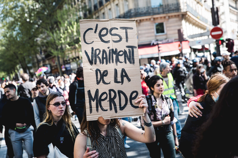 Large crowd holding signs and marching