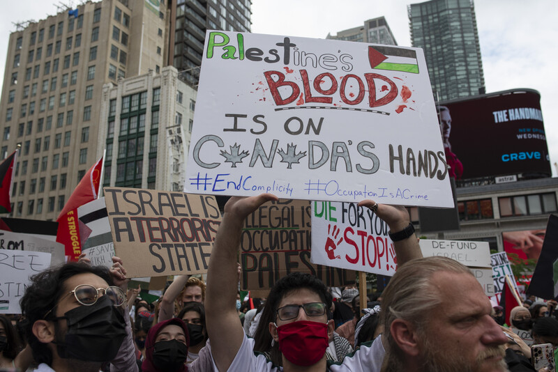 Protesters hold signs