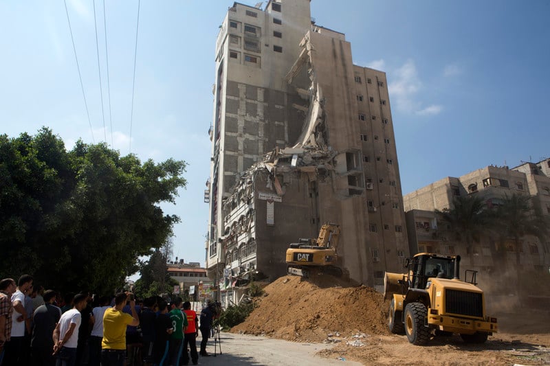 A tall building with many floors that have collapsed