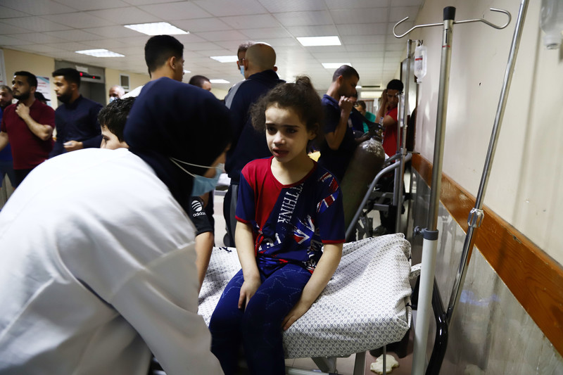 A young girl is treated on a hospital bed