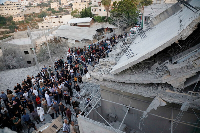 Palestinians gather at the destroyed home belonging to the family of Diaa Hamarsheh after it was demolished by Israeli troops in the town of Yabad, north of the West Bank city of Jenin, on 2 June. Israel destroyed the home in revenge for the killing of four people in a Tel Aviv suburb earlier this year. Hamarsheh was killed in a shootout with police, during which a police officer was fatally injured.  Ahmed IbrahimAPA images