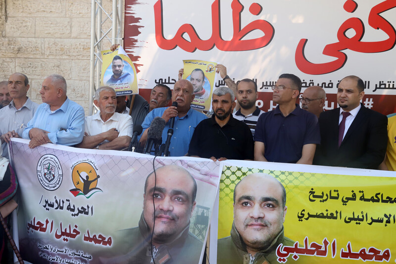 Khalil El Halabi, the father of persecuted aid worker Mohammed El Halabi, speaks during a protest in front of the Gaza City offices of the International Committee of the Red Cross, on 15 June. An Israeli court issued a guilty verdict against the younger El Halabi after a six-year trial over manufactured “terror” financing charges rejected by the international Christian charity World Vision, where El Halabi worked before his arrest.  (Youssef Abu Watfa/ APA images)