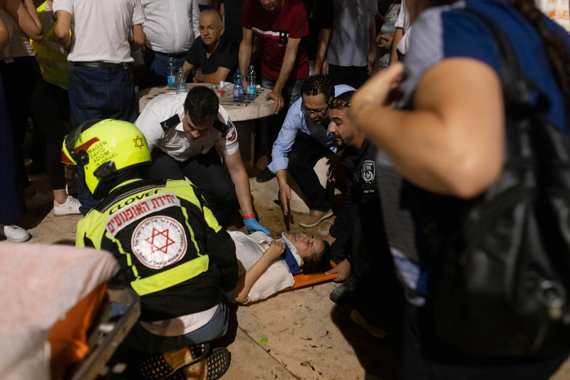Medics treat one of two protesters injured after they were run over intentionally by an Israeli scooter driver during a protest marking 55 years of occupation, in Tel Aviv on 19 June.  (Oren Ziv/ ActiveStills)