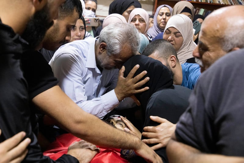 Palestinians mourn during the funeral for Ali Hasan Harb in the West Bank village of Iskaka on 22 June. Harb was fatally stabbed by a Jewish settler the previous day while defending his land from colonization near Ariel settlement.  (Oren Ziv/ ActiveStills)