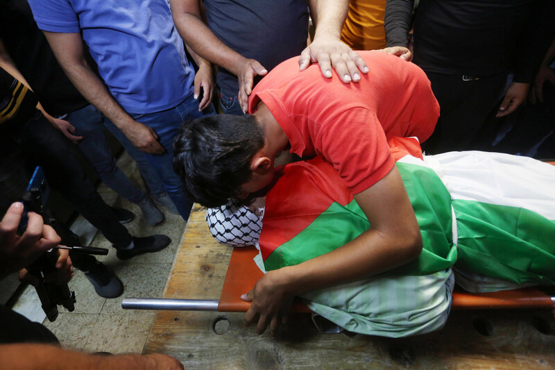 Palestinians mourn Nabil Ghanem, a Palestinian father who was killed while trying to cross Israel’s wall in the West Bank days earlier, during his funeral in Nablus on 23 June.  (Shadi Jarar’ah/ APA images)