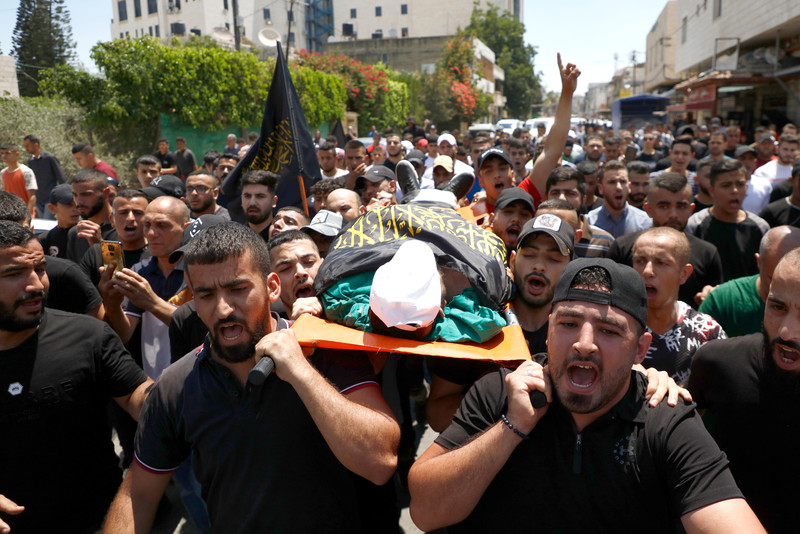 Mourners carry the body of Muhammad Maher Marei, an Islamic Jihad fighter who was killed during an Israeli raid, during his funeral in the West Bank city of Jenin on 29 June.  (Ahmed Ibrahim/ APA images)