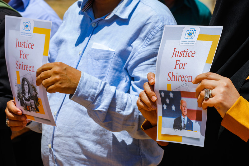 Two people hold up posters with "Justice for Shireen" written on them