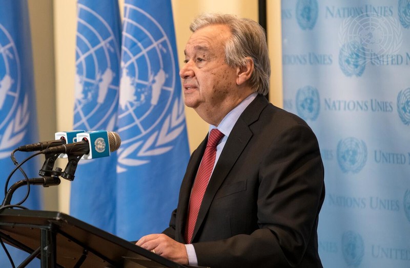 Man speaks at podium in front of UN flag