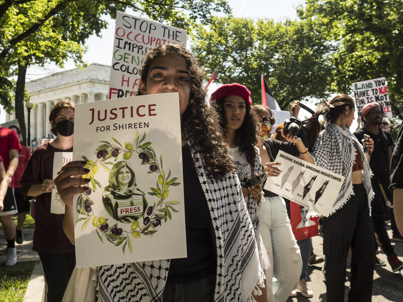 Protesters holding signs