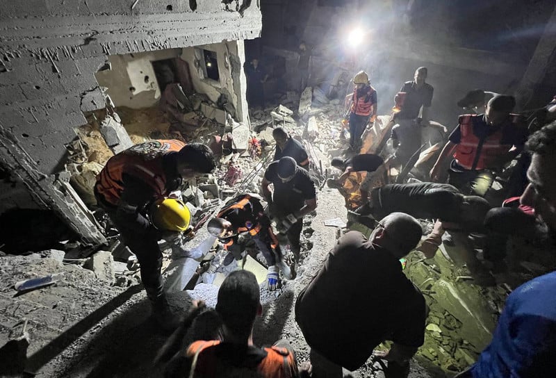 Palestinian rescue crews in Rafah search in the rubble for survivors of an Israeli airstrike