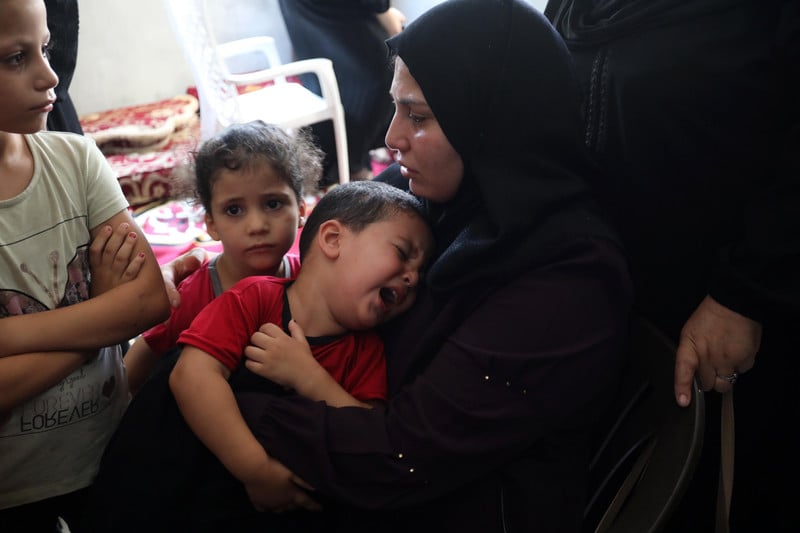 A child cries as a woman hugs him following the Israeli attack on Gaza