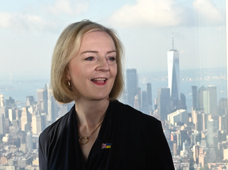 Liz Truss smiles on the backdrop of the New York skyline