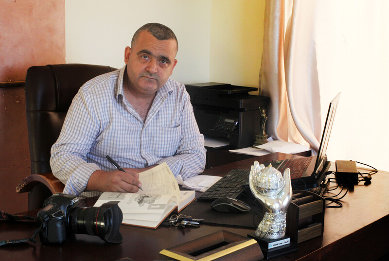 A man sits at a desk