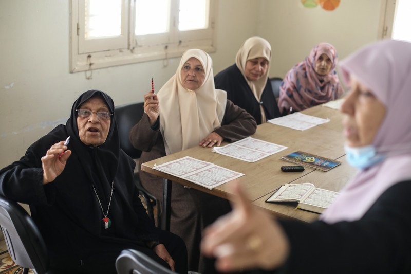 Palestinian women in Gaza in a classroom for reading instruction